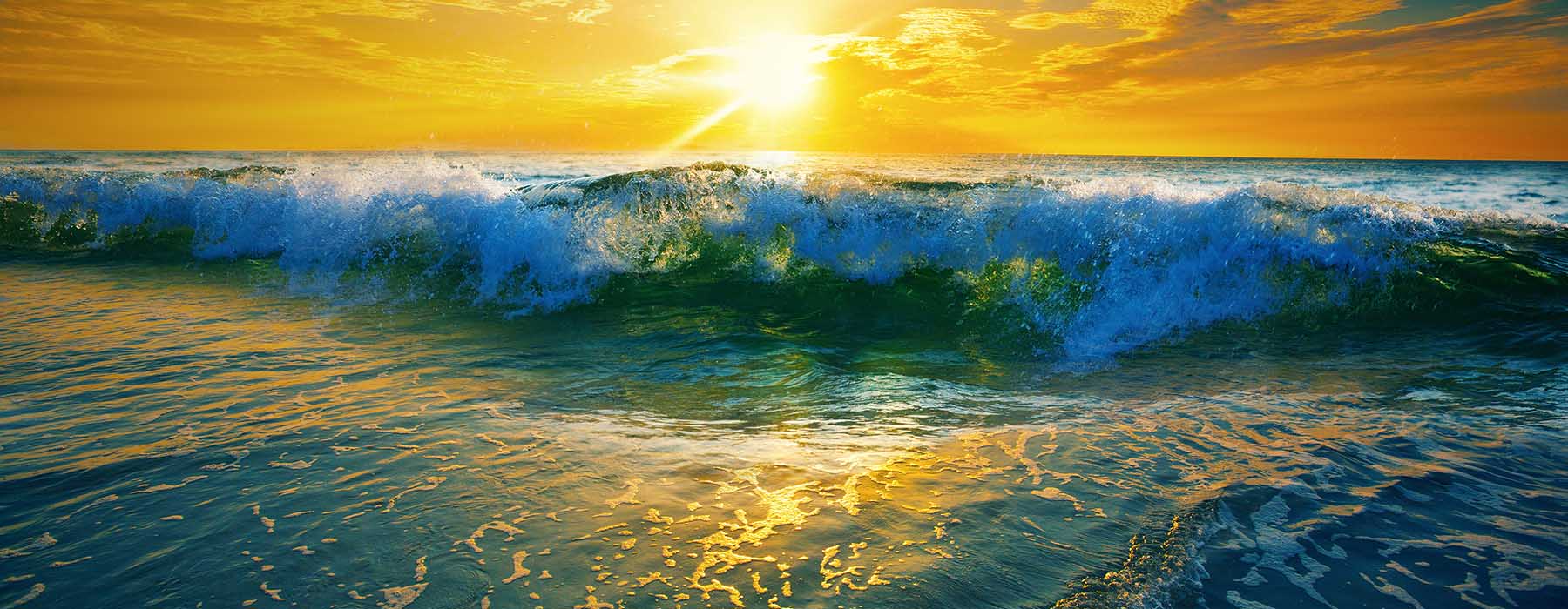 A painting of a sunset over the ocean with waves crashing on the beach.