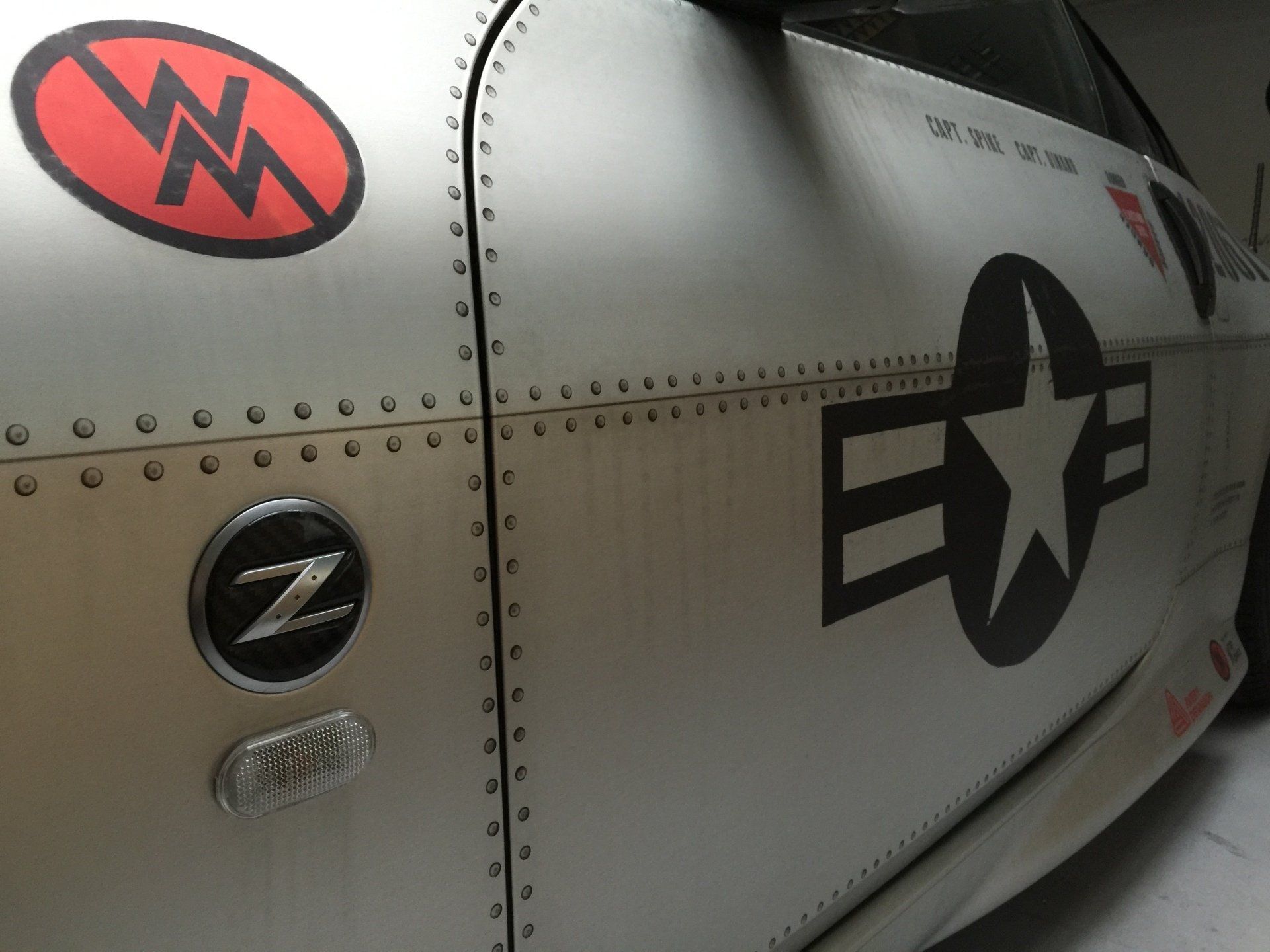 Nissan 350Z Silver matte chrome car wrap  with riveted panels, decorated with a black star emblem and 