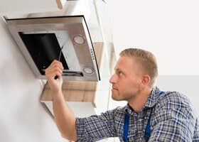 Worker Fixing Kitchen Appliance - Appliance Repair in Newbury Park, CA