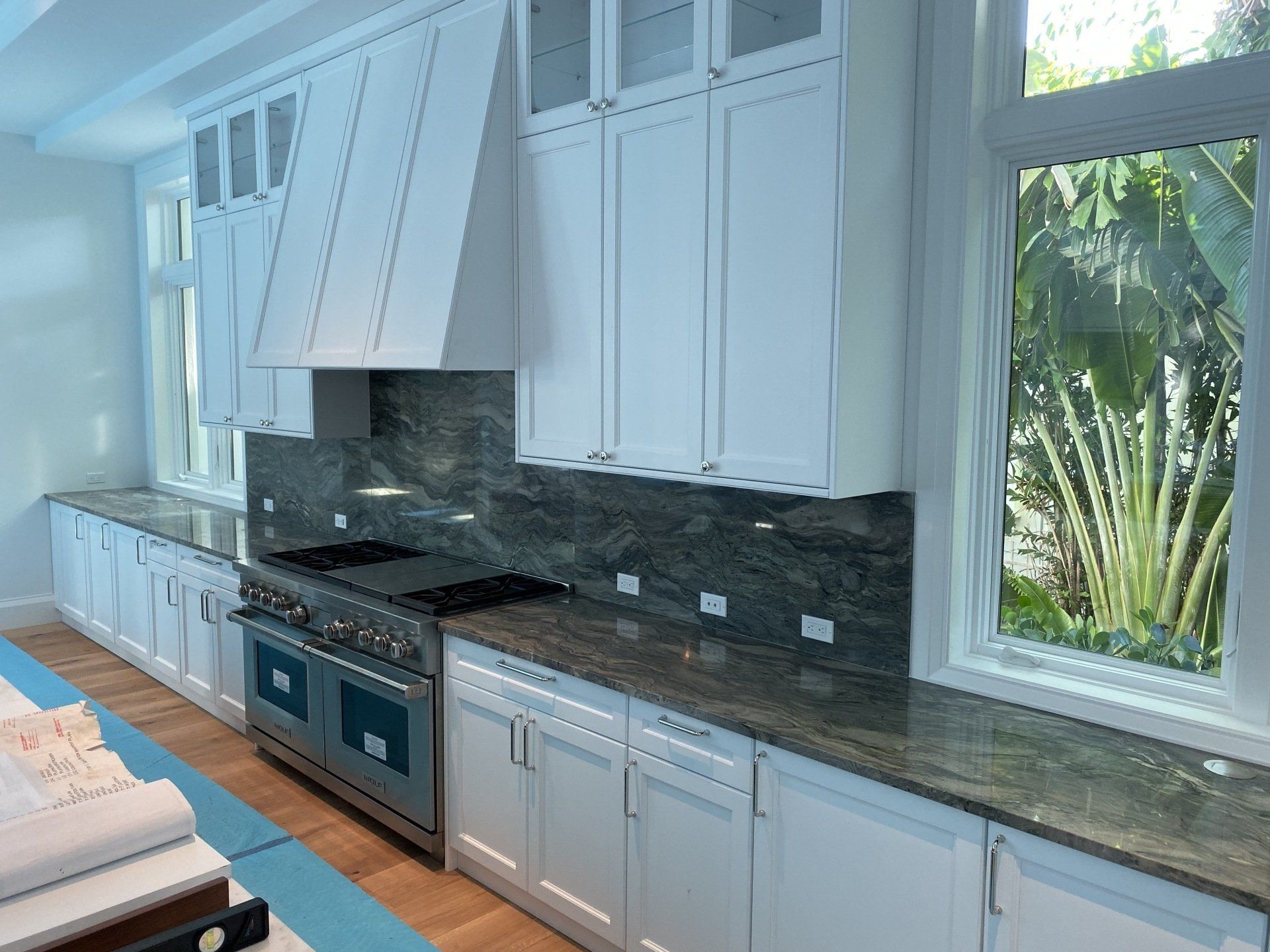 A kitchen with white cabinets and granite counter tops