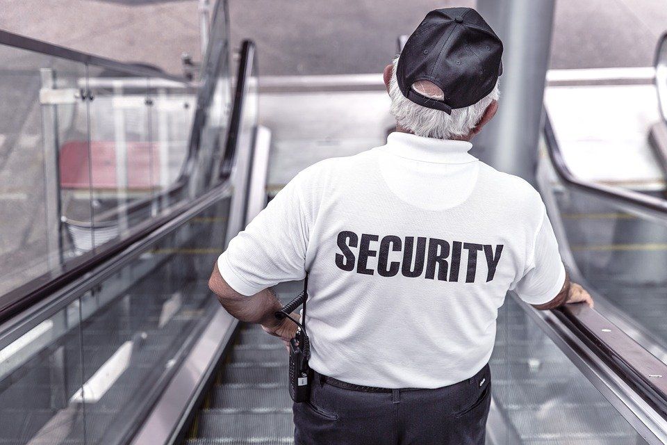 A security officer going down an escalator
