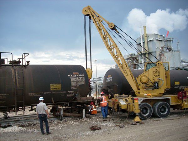 A Hulcher crane and crew change out the wheels on a tanker car