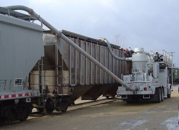 Hulcher's hi-rail transfer vacuum trucks allow the transfer of materials like grain directly from one storage location to another