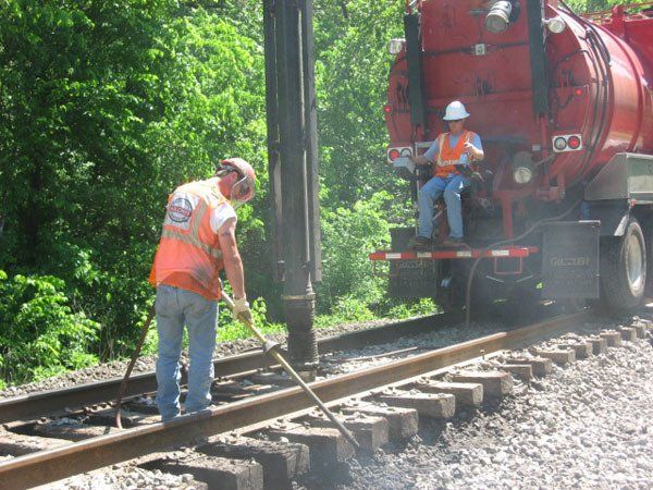 Air Spade and a hi-rail vacuum truck performing air excavation on the right-of-way