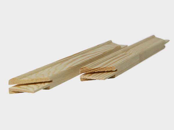 Two light wooden moulding strips with groove cutouts, shown on a white background