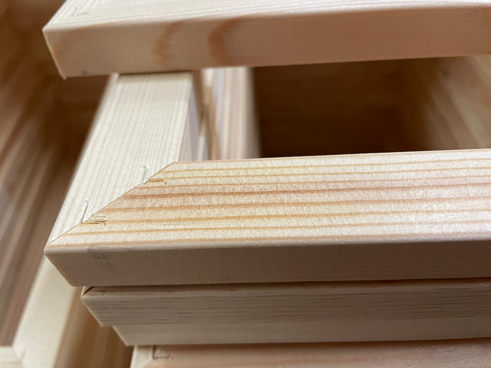 Stacked unfinished wooden blocks with a close-up of pale pine grain
