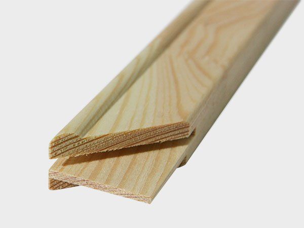 Two light-colored wooden trim pieces with angled ends, stacked diagonally on a white background