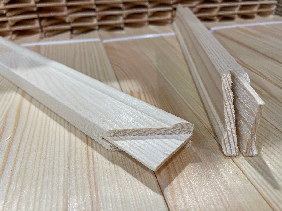 Wooden toothpicks and thin balsa wood strips on a light wood surface