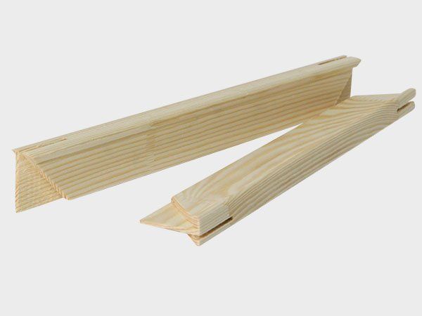 Two light wood lattice trim pieces, one long and one shorter, on a white background