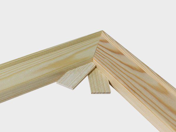 Three light wood planks joined at a corner on a white background