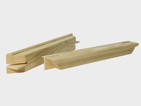 Wooden trim pieces with tongue-and-groove edges, shown on a white background