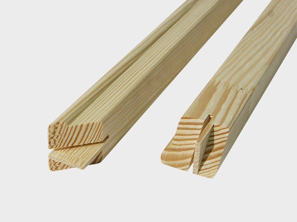 Two light wooden strips with interlocking grooves on a white background
