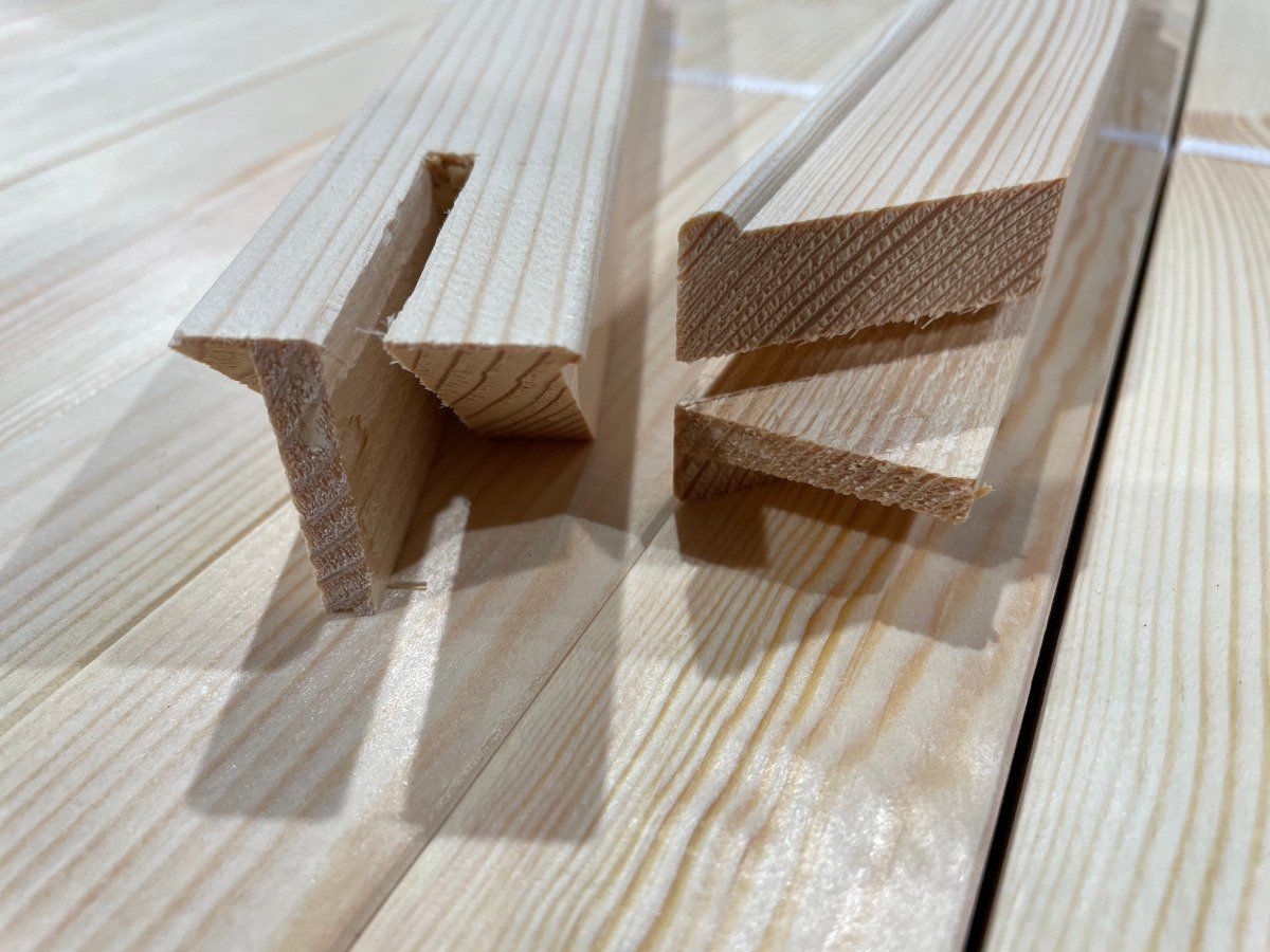 Wooden 3D letters spelling “WE” on a light wood surface