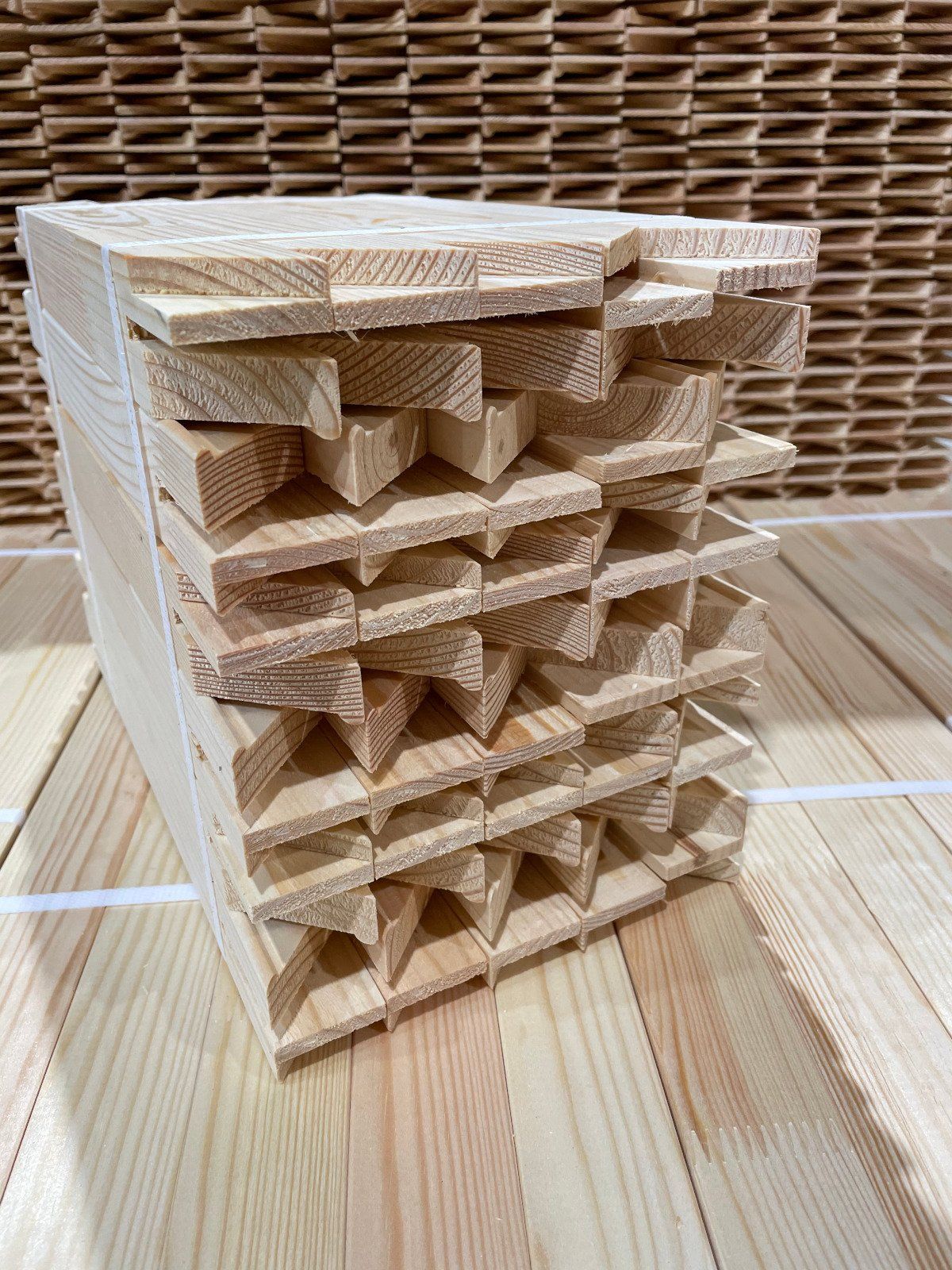 Stacked wooden lattice blocks on a light wood tabletop, with woven baskets in the background.