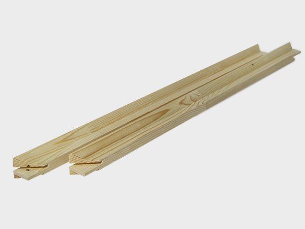 Two light wood floor trim strips with tongue-and-groove edges on a white background