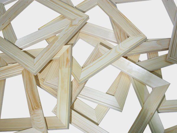 Abstract arrangement of overlapping light wood frames on a white background