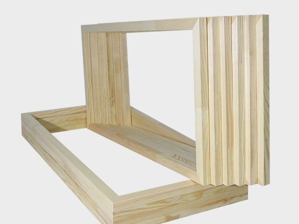 Abstract wooden geometric frame sculpture in light natural wood on a white background