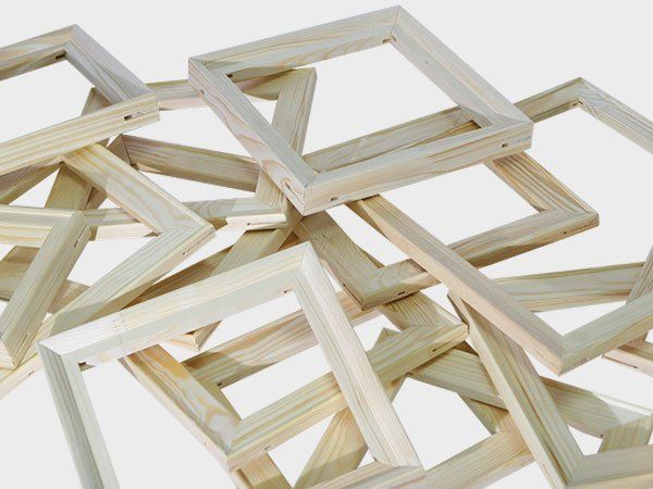 Stacked light wood picture frames on a white background