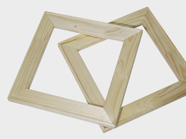 Interlocking unfinished wooden geometric frames on a white background