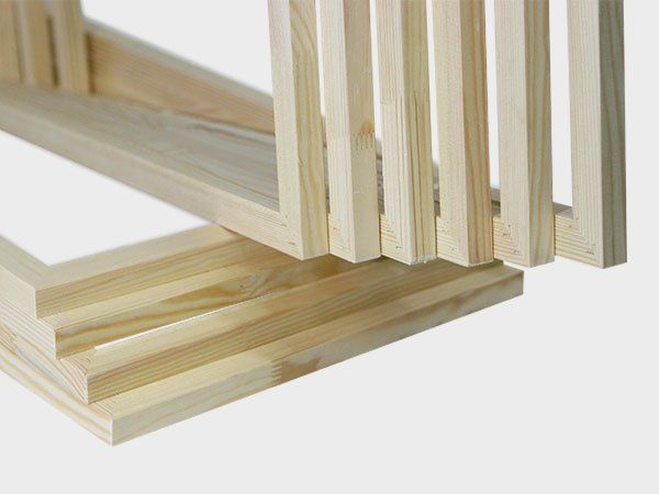 Stacked light wood panels with vertical slats on a white background