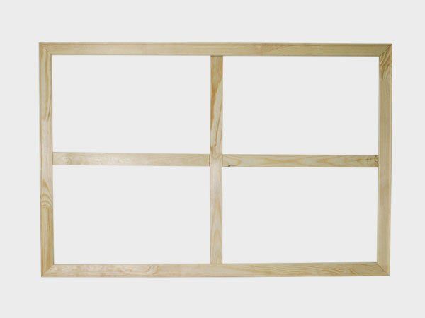 Wooden four-pane window frame on a white background