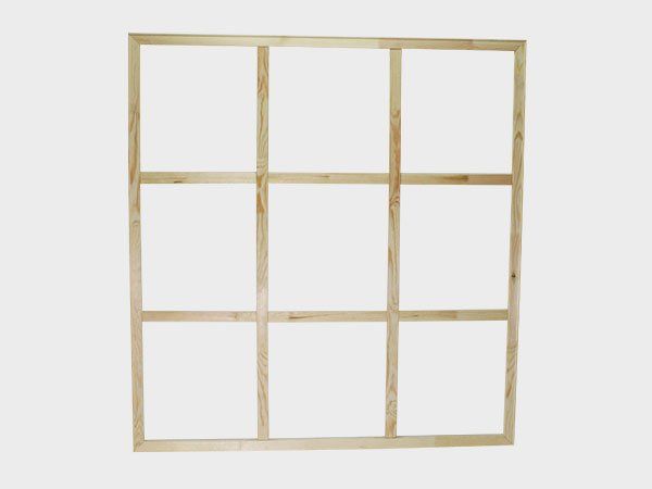 Wooden nine-pane window frame with no glass, against a white background