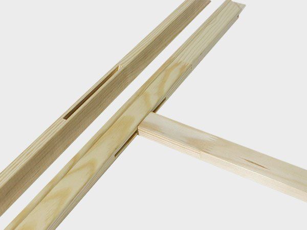 Wooden window frame parts with a diagonal brace on a white background