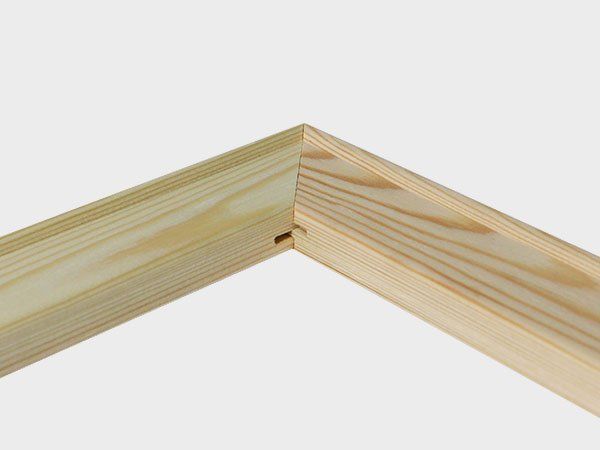 Close-up of two light wood boards joined at a 90-degree corner joint.