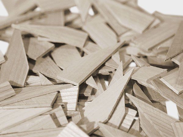 Pile of light-colored wooden wedges scattered in a close-up view