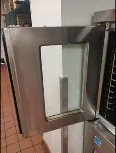 Stainless steel commercial oven with open door showing a glass window.