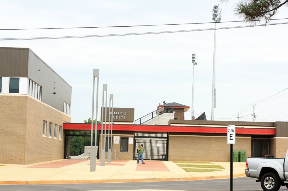 Exterior of a brick and metal building with the words