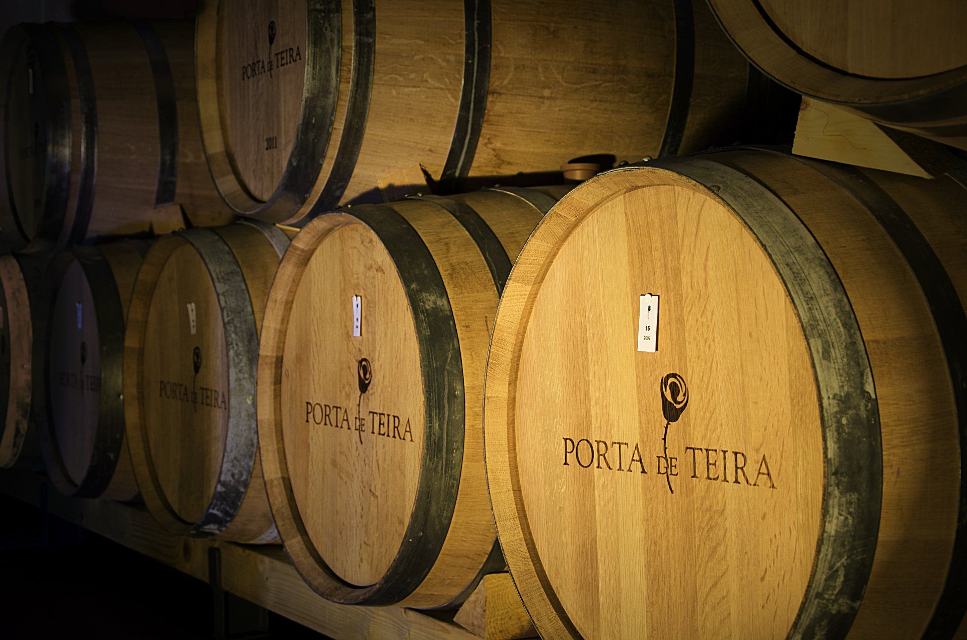 Wooden barrels stacked, labeled 