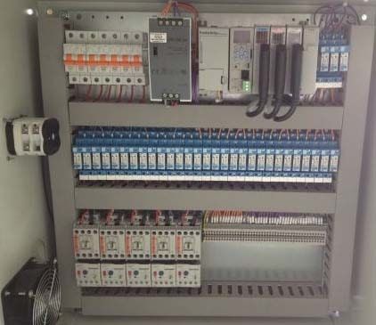A electrical control panel with a lot of wires coming out of it - Electrician in Emerald | All Saints Electrical