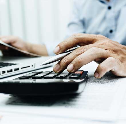 Worker Using a Calculator — Weston, WV — John E Law CPA, A.C. Worker Using a Calculator — Weston, WV — John E Law CPA, A.C.