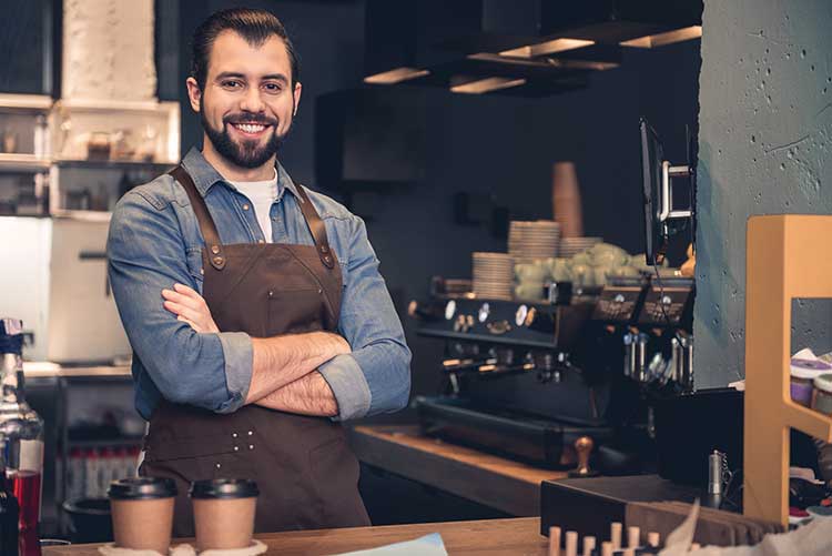 Man Working in Cafe — Weston, WV — John E Law CPA, A.C.
