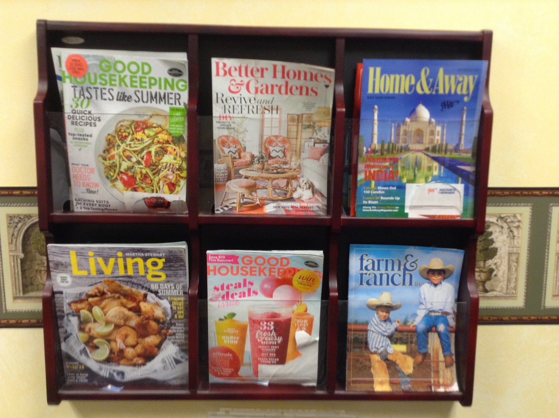 Magazine rack with six magazines: Good Housekeeping, Better Homes & Gardens, Home & Away, Living, Good Housekeeping, and Farm & Ranch.