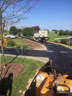 Yellow road roller — Voelker Paving INC In Butler, PA Yellow road roller — Voelker Paving INC In Butler, PA
