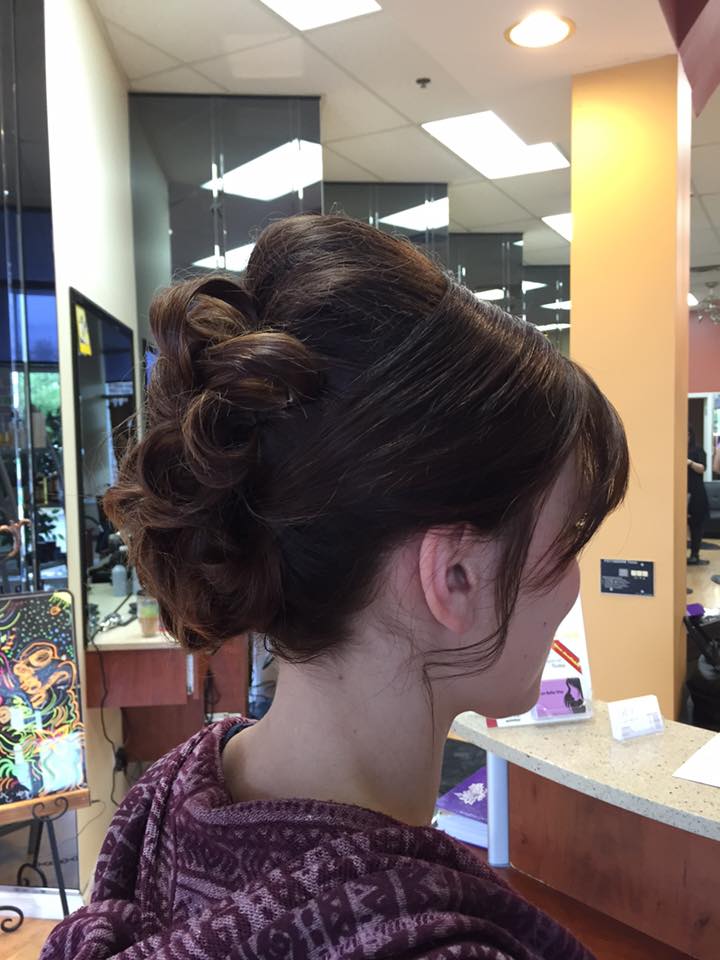 A woman is getting her hair done in a salon