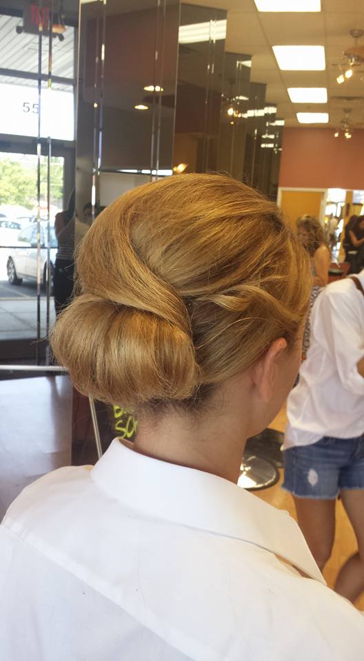 A woman is getting her hair done in a salon.