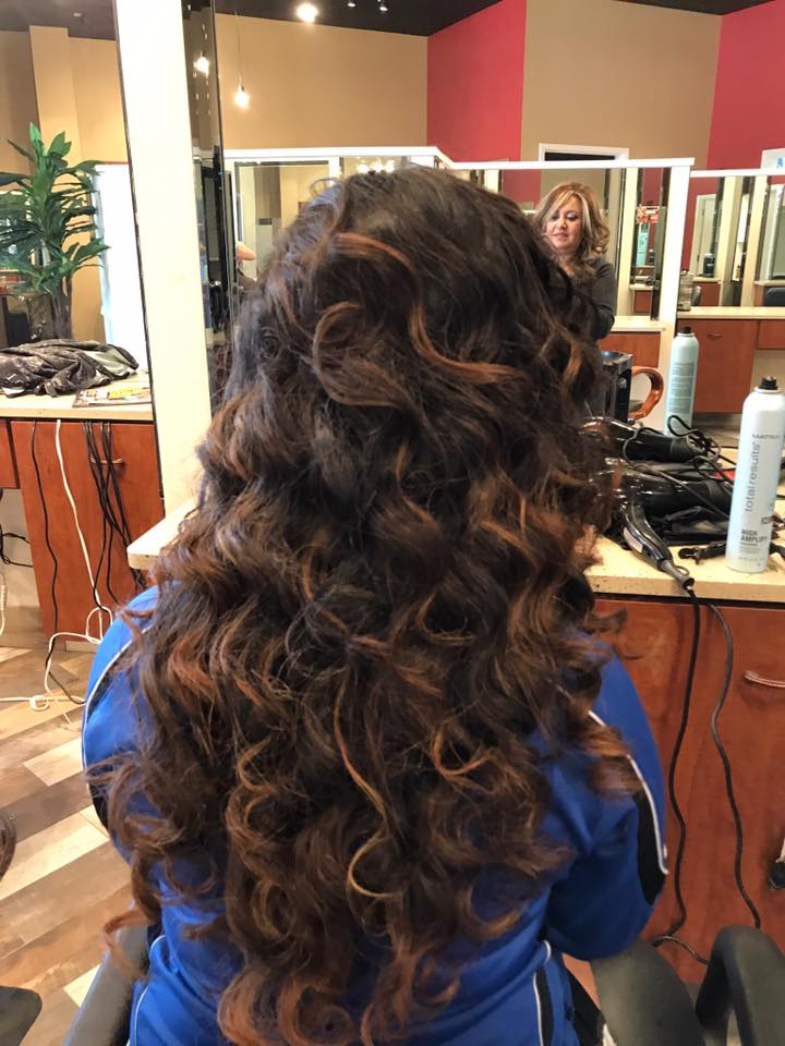 A woman is getting her hair done in a salon.