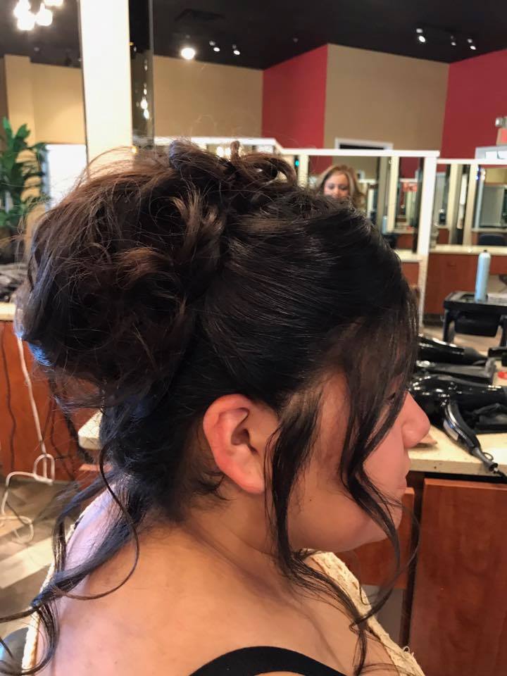 A woman is getting her hair done in a salon.