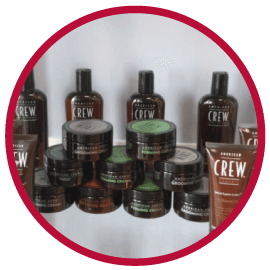 Several bottles of crew products are lined up on a shelf
