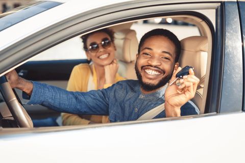 Happy People Inside Car Holding Key — Mount Pleasant, TX — 903 Locksmith Services