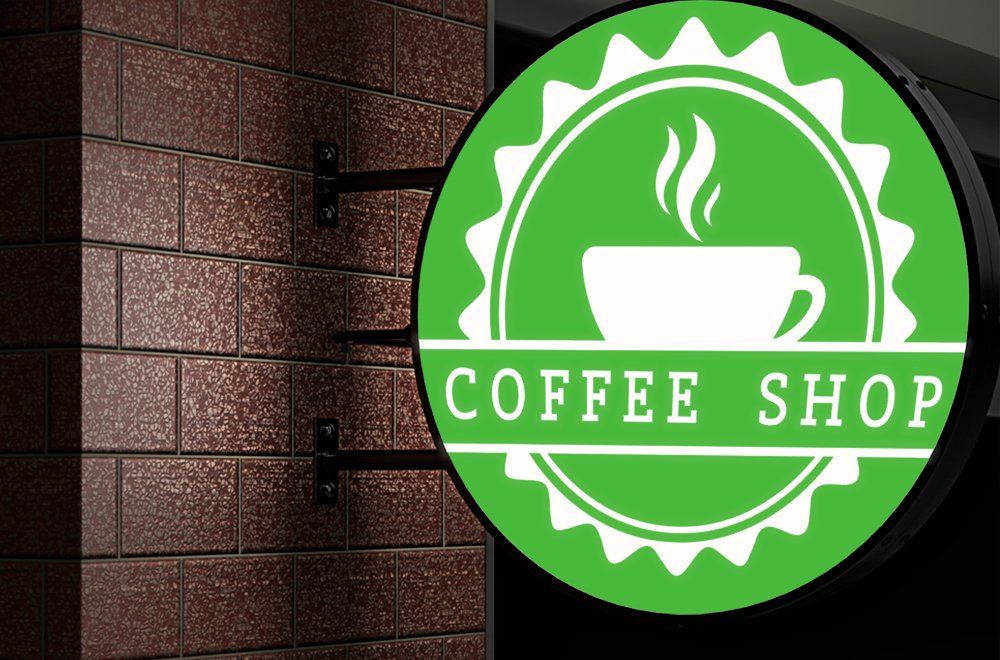 Uma placa circular verde com um ícone de xícara de café e a inscrição