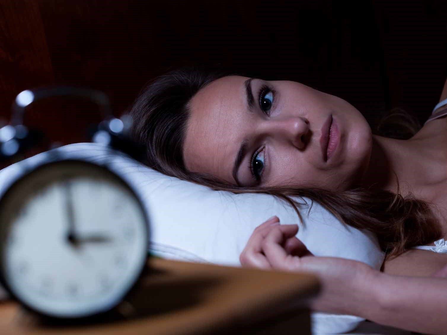 lady in bed watching clock