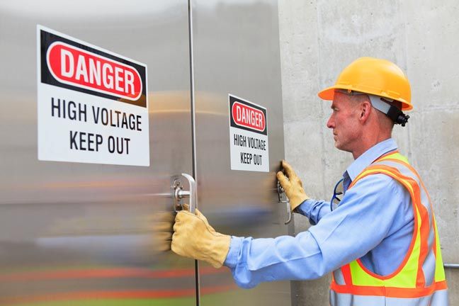High Voltage Electric Contractor — Electrician Working on a Circuit in Burien, WA