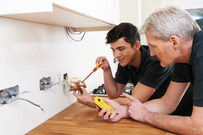 Commercial Construction Electric — Electricians Working on Outlet in Burien, WA