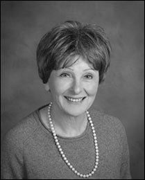 A black and white photo of Myra Levenson wearing a pearl necklace