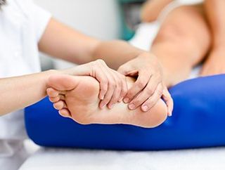 Foot Pain — Doctor Massaging Patient's Foot in East Longmeadow, MA Foot Pain — Doctor Massaging Patient's Foot in East Longmeadow, MA