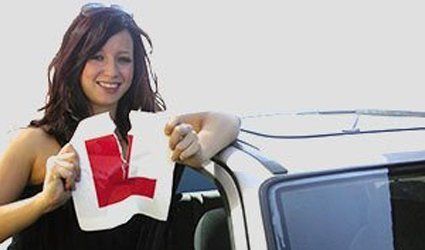 a lady driver tearing the L card